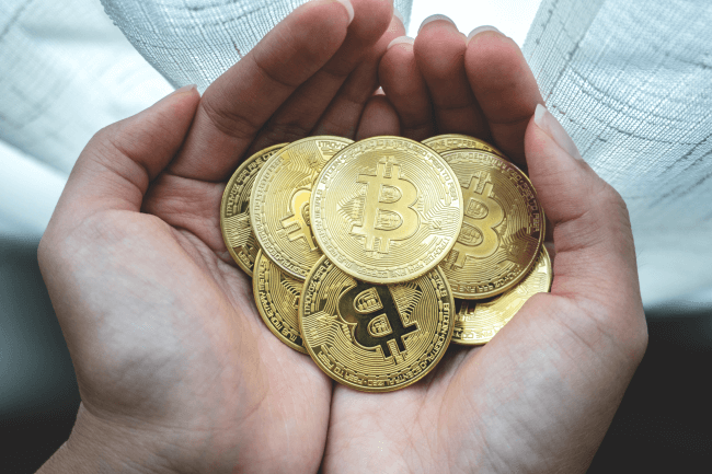 Woman holding bitcoins in hands